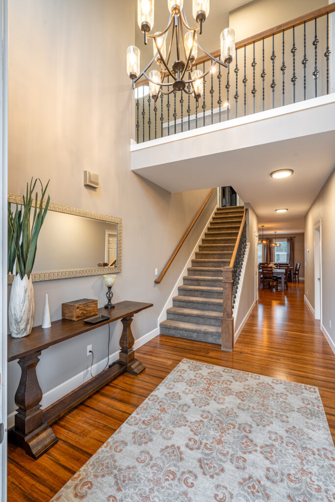Bright two-story entry and staircase — real estate photography by Pro Property Photos by Wasim, Bend, Oregon.