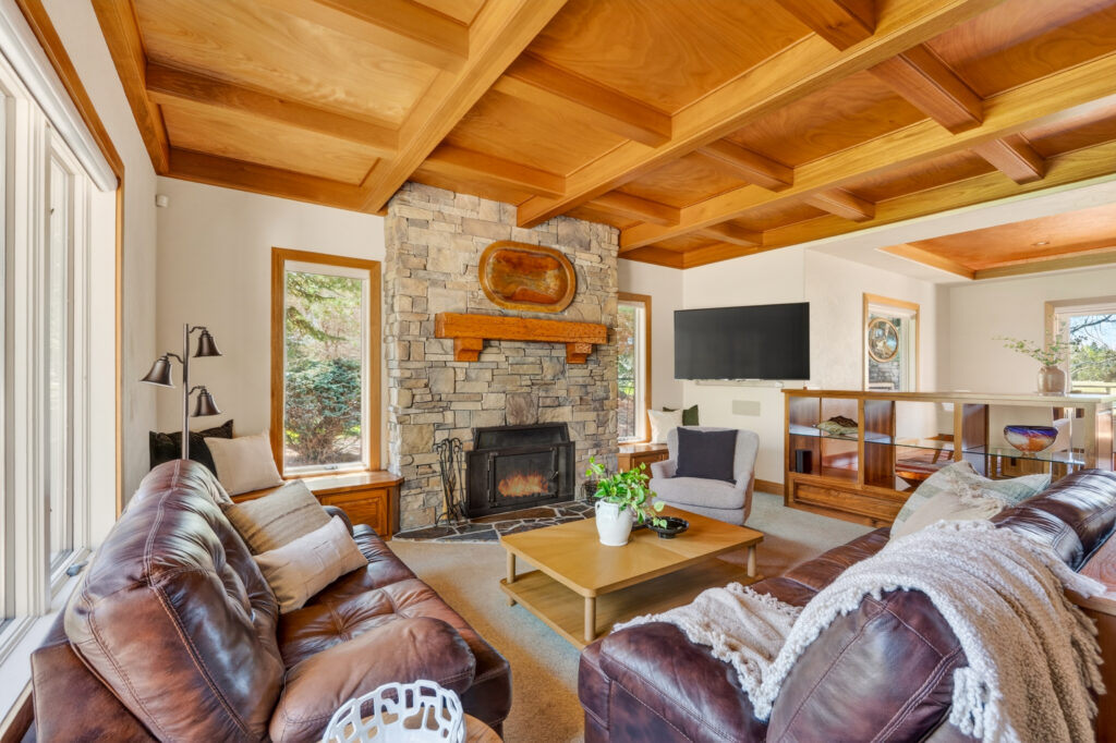 Vaulted living room with ponderosa pine views — real estate photography by Pro Property Photos by Wasim, Bend, Oregon.