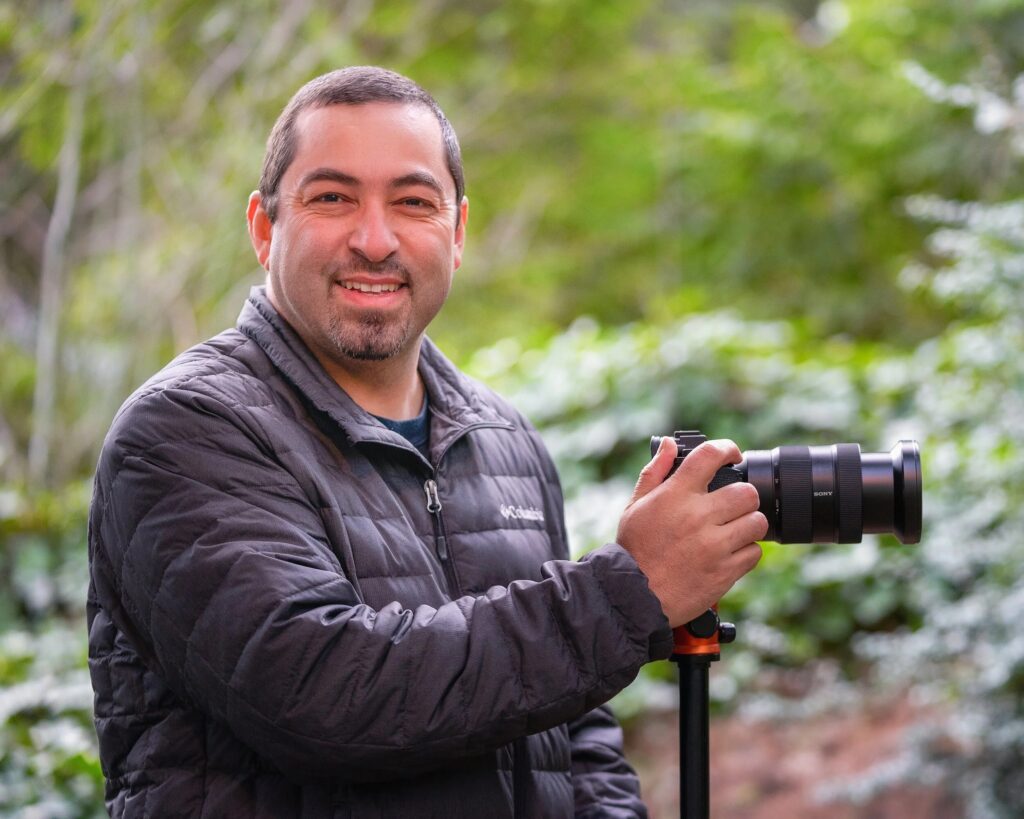 Wasim Muklashy — landscape, nature, and travel photographer — with his camera